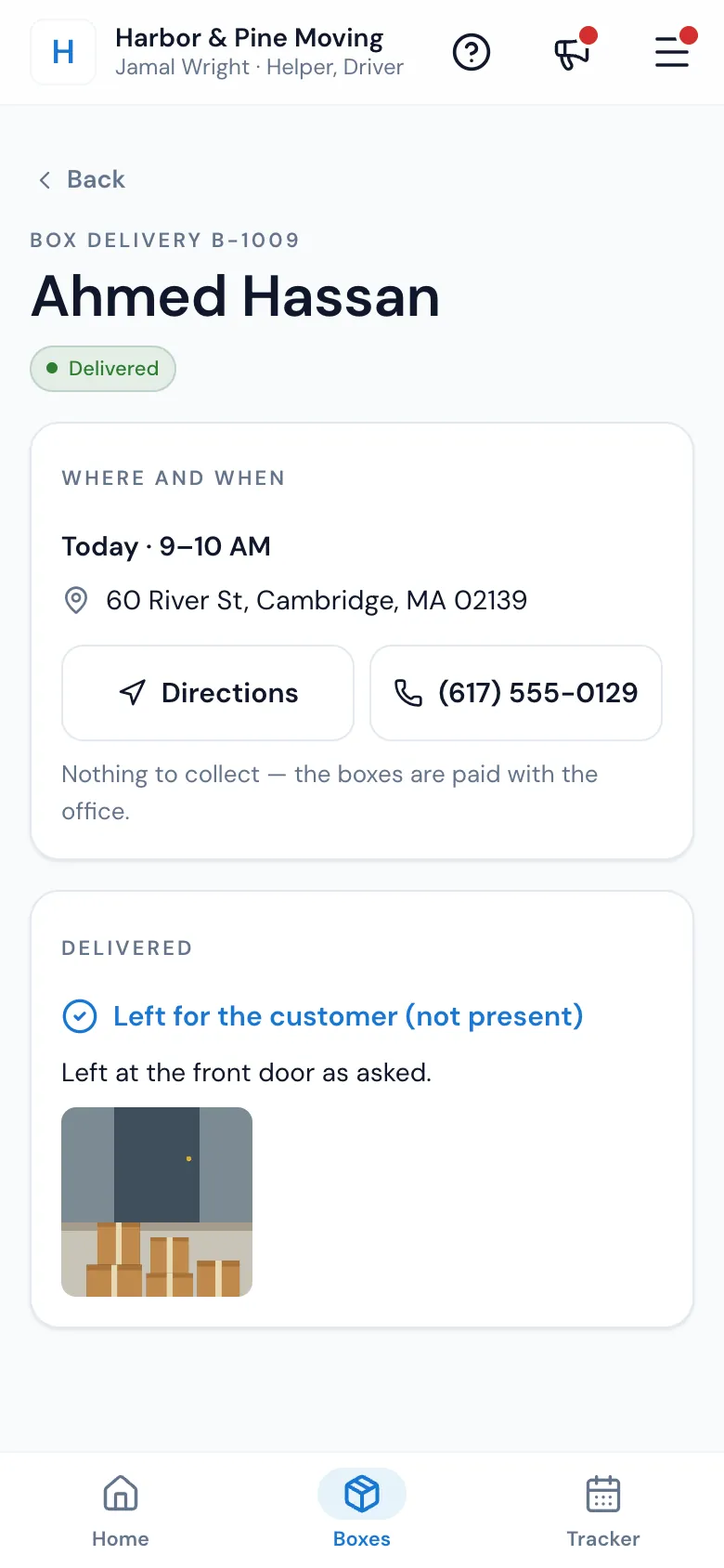 A box delivery on the crew's phone marked Delivered, left for the customer with a photo